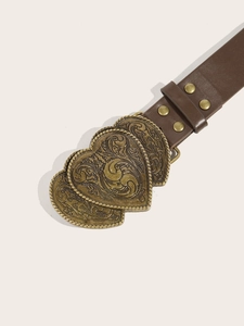Detailed view of bronze heart-shaped buckles with embossed texture on brown PU leather belt