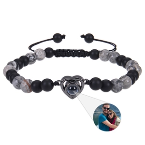 Detail of custom heart projection pendant with 6mm matte black and marble stone beads