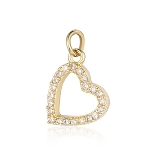 Macro shot of a golden heart-shaped key pendant with clear cubic zirconia insets