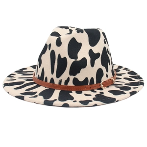 Stylish cow print fedora hat with wide brim and brown leather belt buckle accessory