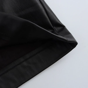 Close-up detail of the premium black PU leather texture and neat stitching on short skirts