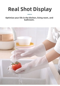 Waterproof cream-colored latex kitchen gloves shown washing fresh tomatoes in a sink