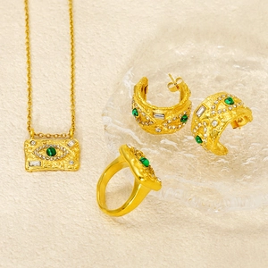 Detail of 18K gold plated jewelry set with green malachite and zircon evil eye design