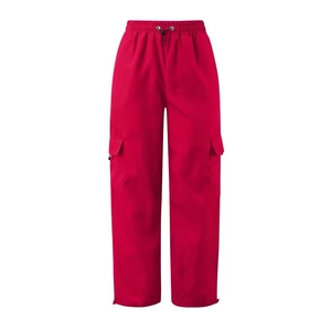 Detailed view of red cargo pants with elastic drawstring waist and side pockets