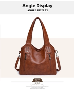 Detailed front view of a brown vintage tote bag featuring symmetric vertical zipper pockets