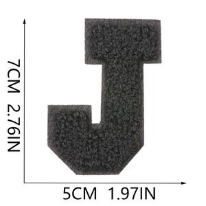 Detailed close-up of 7cm black chenille letter J patch with embroidered texture and size marks