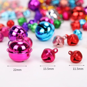 Detailed macro view of colorful metal bells in sizes of 22mm, 13.5mm and 11.5mm