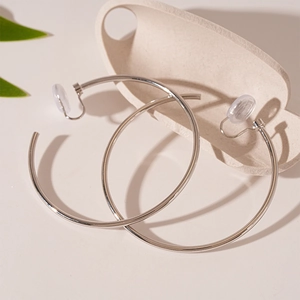 Detail view of silver geometric hoop clip-on earrings with comfortable silicone pads