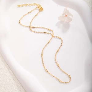 Gold plated bead chain necklace with lobster clasp on elegant white stone tray