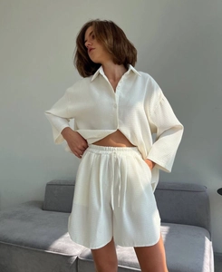 Detail of white waffle knit fabric texture on long sleeve shirt and drawstring shorts