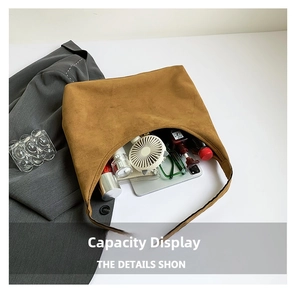 Brown suede tote bag detail showing large capacity for gadgets and daily essentials