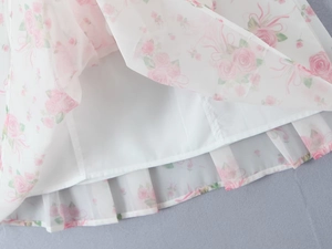 Detail of floral chiffon fabric showing pink rose pattern and white inner lining