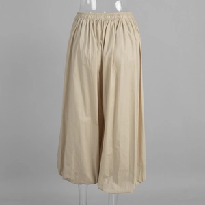 Detail of elastic waist and beige cotton fabric balloon hem casual trousers