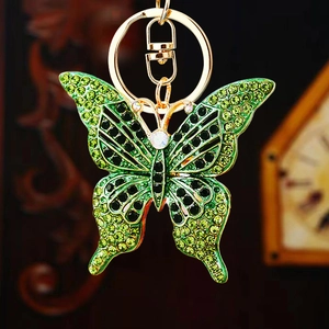 Creative butterfly keychain with green and black rhinestones on a golden metal ring