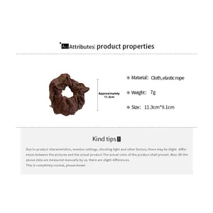 Detail showing dark brown hollow lace embroidery texture and elastic cloth hair scrunchie