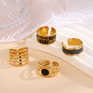 Gold adjustable open rings set with black enamel accents and geometric vintage designs