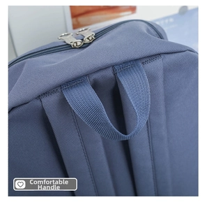 Close-up of durable fabric texture and reinforced handle on the blue canvas backpack