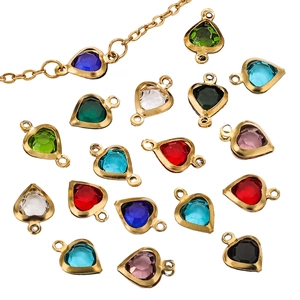 Macro shot of colorful heart-shaped crystal charms with gold-plated metal settings