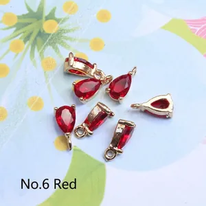 Detailed view of faceted red teardrop crystal pendants with gold plated metal base