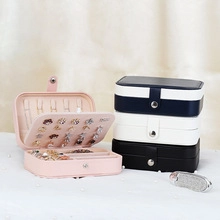 Detailed interior view of a portable faux leather jewelry box with earring and ring slots