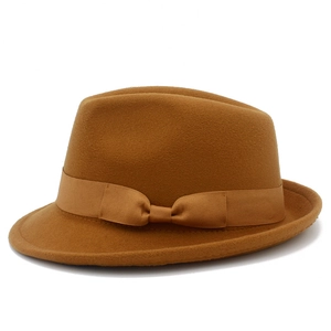 Detail of brown wool felt jazz hat featuring a matching grosgrain ribbon and bow decoration