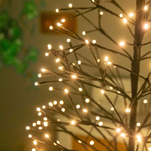 Artificial black Christmas tree with warm white LED lights for festive holiday decoration
