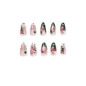 Christmas press-on nails with festive green and white French tips and snowflake designs