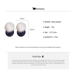 Detail view of round hairball resin earrings in black and white with 3.5cm diameter size info
