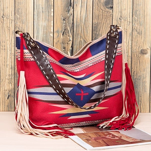 Close-up of red Bohemian woven tote featuring geometric patterns and long side tassels