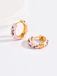 Macro detail of vintage floral enamel hoop earrings with pink finish and white petals