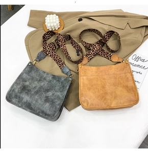 Detail of vintage tote bags in charcoal and caramel with leopard print wide straps