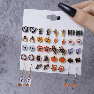 Detail of Halloween earrings set with pumpkin, ghost and bat charms on display card