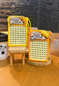 Close-up of toast-shaped magnetic bead stress relief keychain with cute studio design