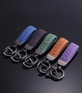 Detailed row of five suede leather braided car keychains in assorted premium colors