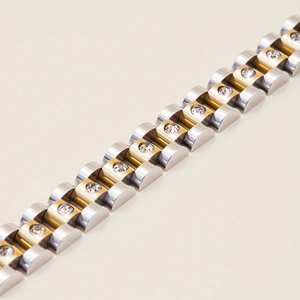 Detailed macro view of two-tone stainless steel bracelet with cubic zirconia inlay