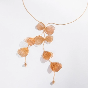 Collier élégant à glands en feuilles de ginkgo dorées avec perles sur fond blanc pur
