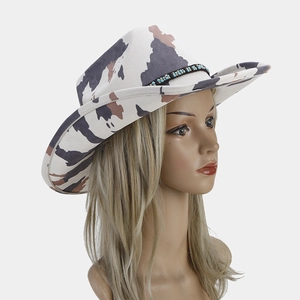 Detail of western cow print cowboy hat with braided leather strap and blue beads