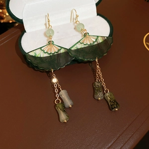 Chinese style resin fan earrings with bamboo leaf pattern and green tassels on velvet box