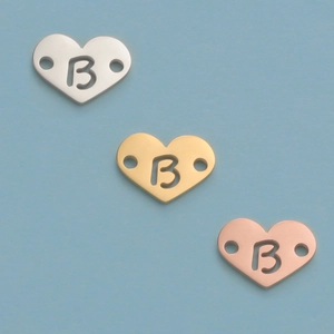 Polished heart-shaped charms in silver, gold and rose gold with letter B engraving