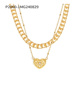 Detail view of gold layered heart necklace with a large hollow pendant and clear zircon