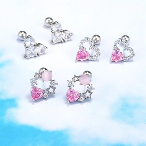 Close-up of pink heart and star piercing studs set with silver screw ball backs