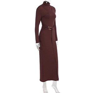 Detail of elegant burgundy long sleeve dress featuring draped waist and gold metal buckles