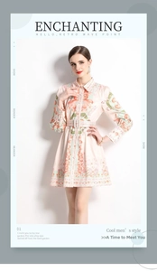 Detail of vintage floral pattern on pink V-neck dress with matching belt and long sleeves