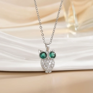 Vintage silver owl necklace with green gemstone eyes and clear crystal pavé pendant
