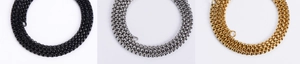 Detailed view of metal box chains in black, silver, and gold finishes on a white background