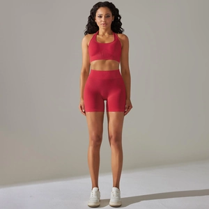 Front view of seamless red yoga set with halter sports bra and high-waist biker shorts