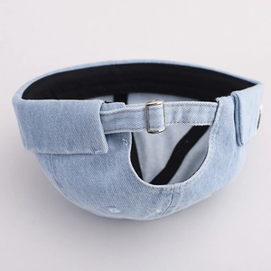 Detail of light blue denim docker cap featuring adjustable silver metal buckle and strap