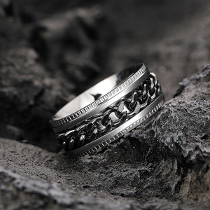 Macro shot of rotating Cuban chain detail on industrial stainless steel men's ring