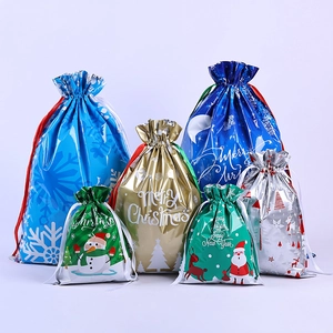 Assorted Christmas drawstring gift bags in metallic blue, gold, and silver foil colors