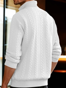 Macro shot of the white heavy-knit cable texture on the back of the vintage sweater